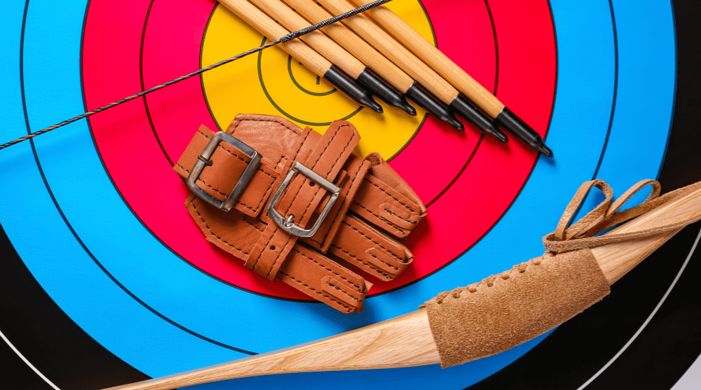 Some archery equipment lying on an archery target.