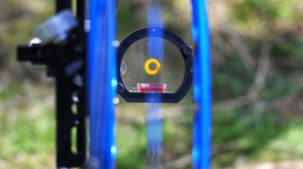 Looking through a bow sight in archery.