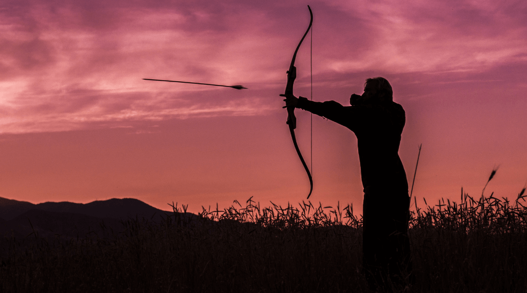 An archer shooting a recurve bow.